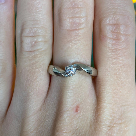 Gold ring with a diamond on a finger